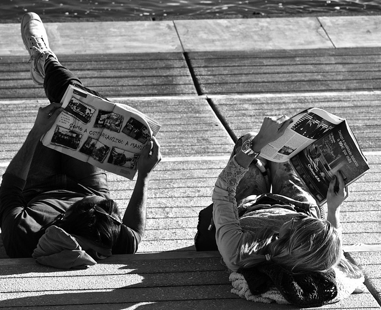 Couple Reading the News on a Sunny Afternoon